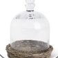 Glass cloche on wicker tray