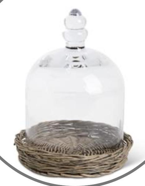 Glass cloche on wicker tray