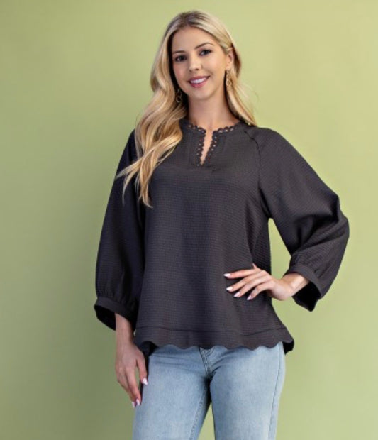 Textured long sleeve top with scalloped hem