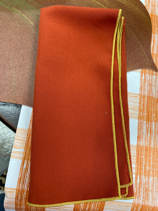 Burnt orange napkin w gold trim