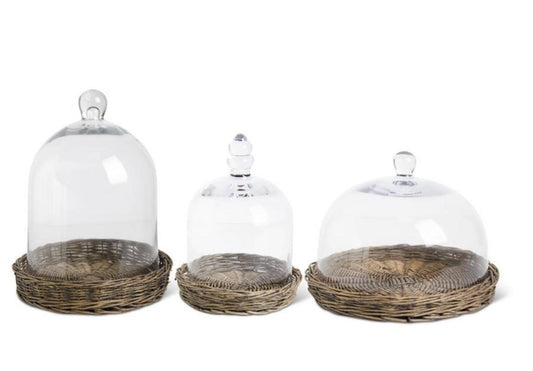 Glass cloche on wicker tray