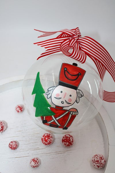 Hand painted glass on red and green toy soldier