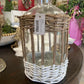 Clear glass bottle in woven rattan basket