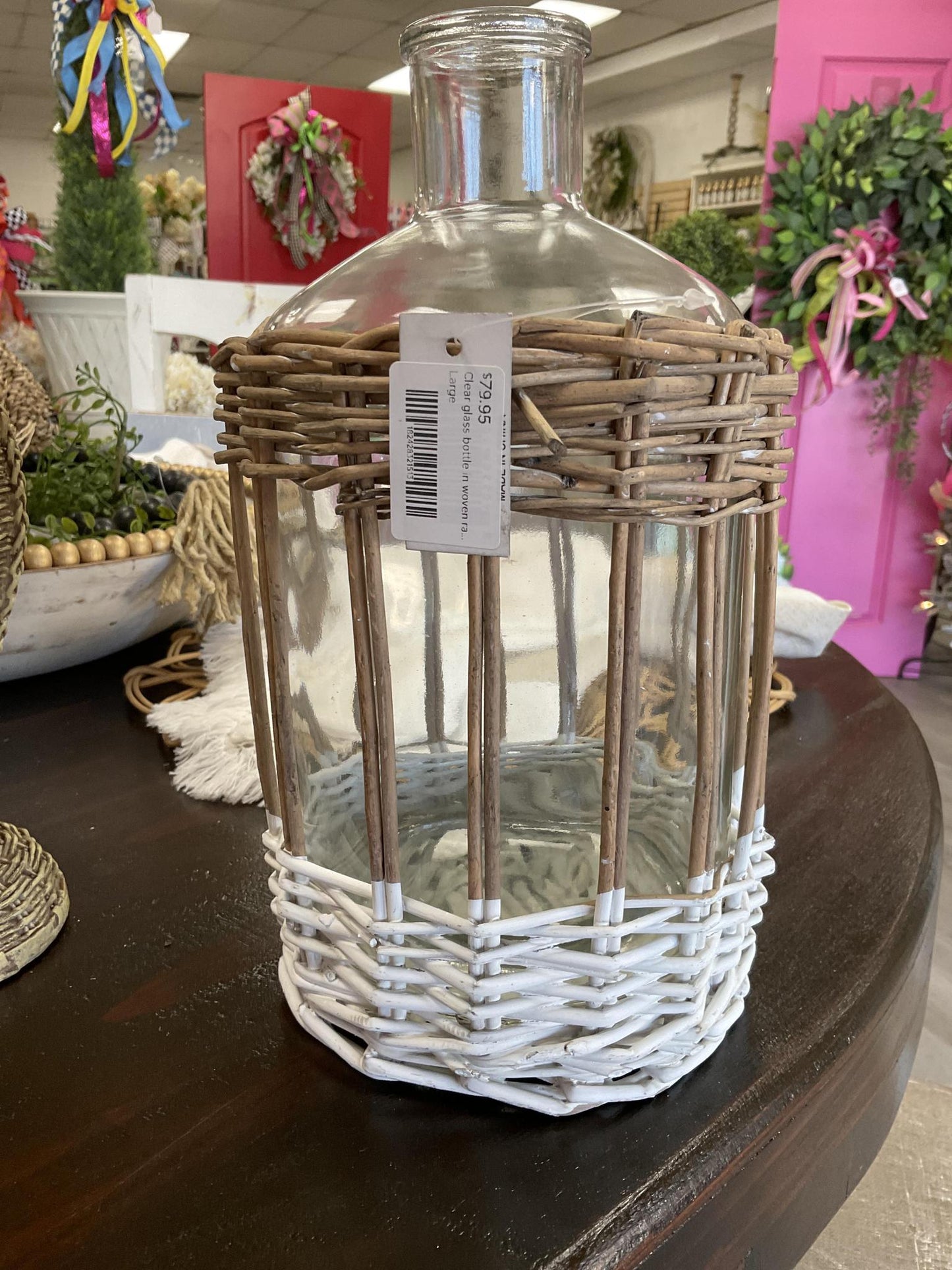 Clear glass bottle in woven rattan basket