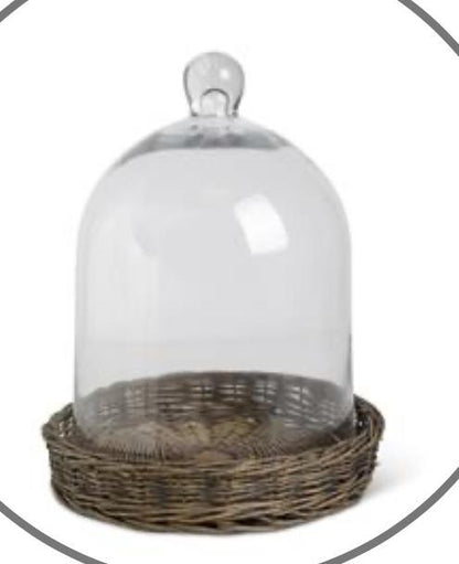 Glass cloche on wicker tray