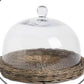 Glass cloche on wicker tray