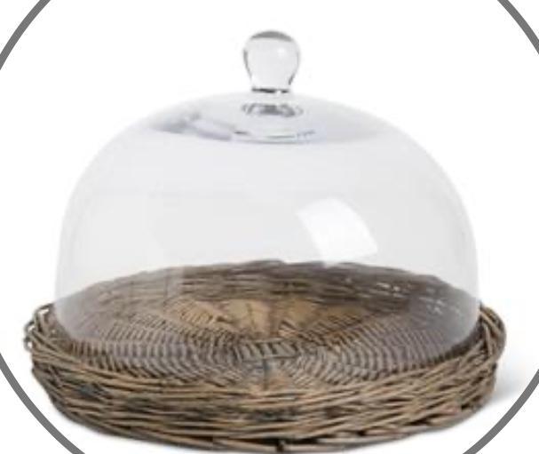 Glass cloche on wicker tray